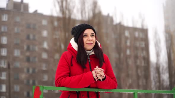 Young Woman in Hat and Red Jacket Standing on Street