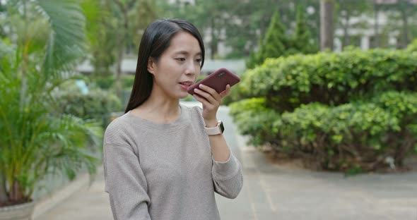 Woman check on smart phone in city