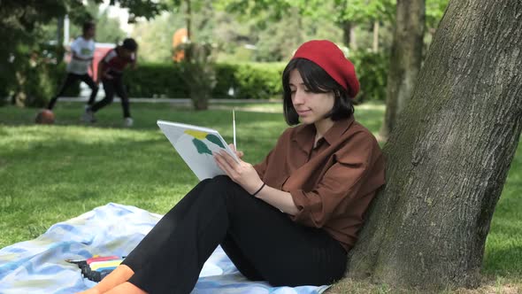 Artist Painting Canvas On Grass