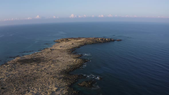 Flyover Rocky Island in Italy. Aerial drone view of  Seascape. Flying on a drone