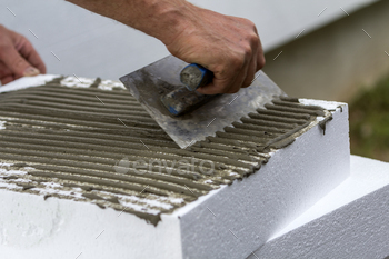 on white rigid polyurethane foam sheet for house insulation. Modern technology, renovation, professional job, alternative for mineral wool concept.