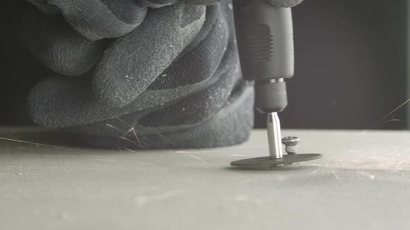 Electric cutter cuts a small screw stuck in the wood