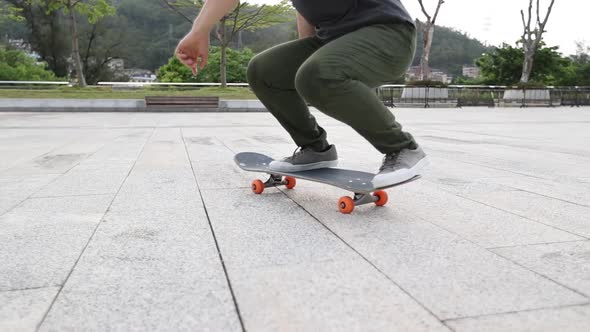 Asian woman skateboarder legs skateboarding outdoors