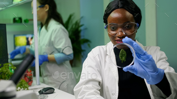 sing medical gloves and glasses. Biochemist scientist working in biotechnology organic laboratory for chemistry experiment