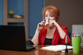 Businesswoman drinking tea while working on laptop at the office - PhotoDune Item for Sale