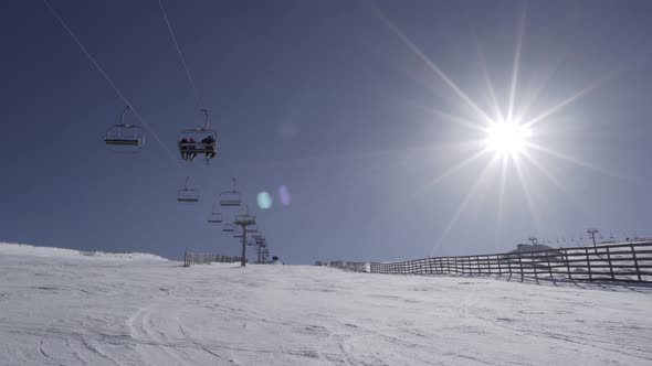 People on chairlift upping on snow mountain