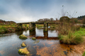 The ancient clapper bridge crossing the East Dart River at Postbridge - PhotoDune Item for Sale