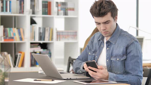 Creative Man Using Smartphone for Work