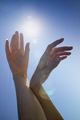 Female hands in the blue sky in the backlight - PhotoDune Item for Sale