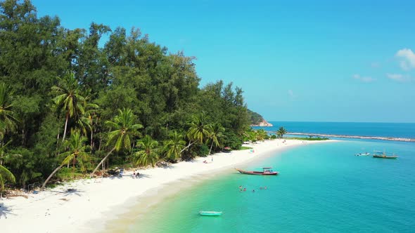 beautiful peaceful island beach, calm turquoise lagoon with mountain jungle in the background. Thail