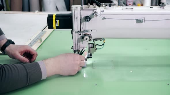 Operator Is Serving Computerized Automatic Quilting Machine Close Up