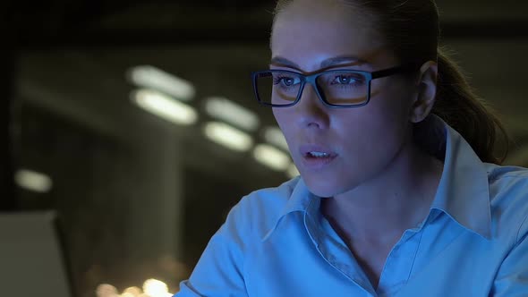 Attractive Business Lady in Eyeglasses Typing Laptop at Night Close-Up, Overtime