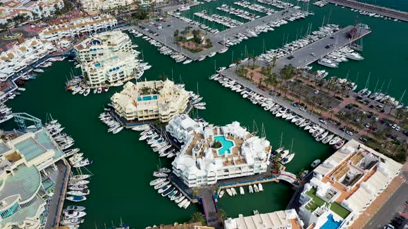 Aerial view of luxury resort with yacht in Benalmádena, Malaga, Spain.