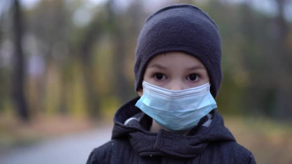 Boy in Medical Mask on the Street