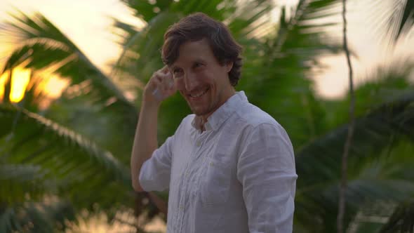 Superslowmotion Shot of a Young Man Applying an Antimosquito Repellent Spray on His Skin. A Tropical