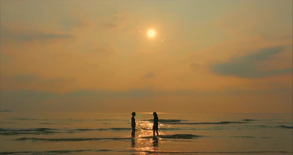 Young Couple Looking Towards the Sun, Against the Sunset, Holding Hands, Go To the Sea