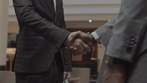 Unrecognizable Business Partners Shaking Hands