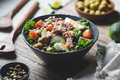 Canned tuna salad with fresh vegetables, capers and olives in a black bowl. - PhotoDune Item for Sale