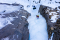 Woman is leading on Ice. Ice Climbing on Frozen Waterfall, Aerial View. Barskoon Valley, Kyrgyzstan - PhotoDune Item for Sale