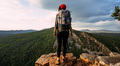 A traveler with a backpack in the mountains at sunset - PhotoDune Item for Sale