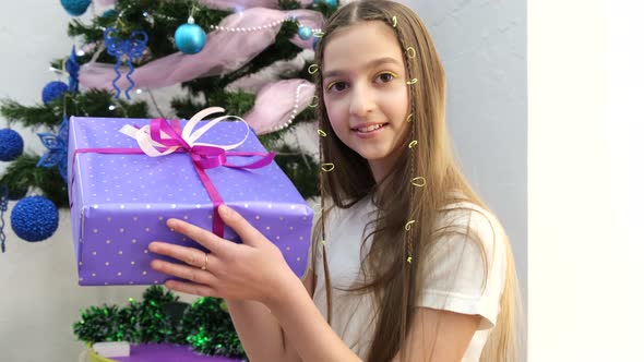 Muslim Little Girl Holding a Gift on Eid alFitr or Eid alFitr  Muslim Holiday