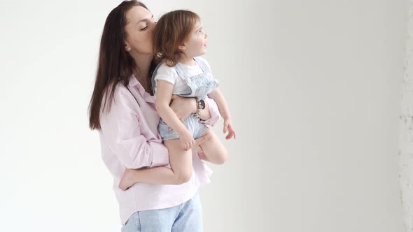 Beautiful Happy Family in a White Photo Studio