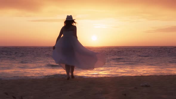 Silhouetted Happy Young Woman Running By Ocean Beach Scenic Golden Pink Sunset