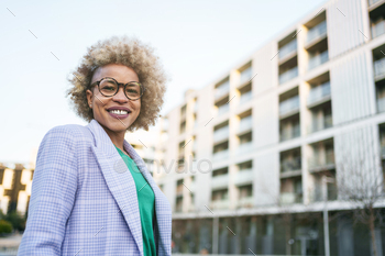 Black Woman Real State agent standing in front of social housing building apartment
