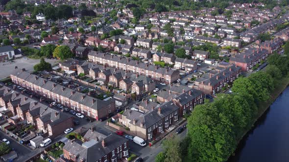Aerial view flying above wealthy Cheshire real estate housing property zoom in to close up shot