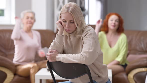 Portrait of Gorgeous Frustrated Slim Beautiful Woman Sitting on Chair with Sad Facial Expression As