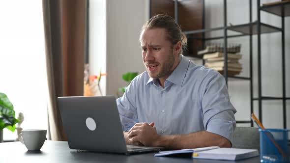 Annoyed Angry Caucasian Businessman Manager Has an Unpleasant Conversation Via Video Conference Uses