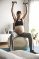 Pregnant woman doing exercises at home - PhotoDune Item for Sale
