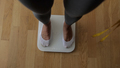 Woman Measuring Body Weight On Weighing Scale At Home - PhotoDune Item for Sale