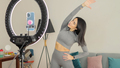 Virtual online fitness. Woman virtual workout at home living room - PhotoDune Item for Sale