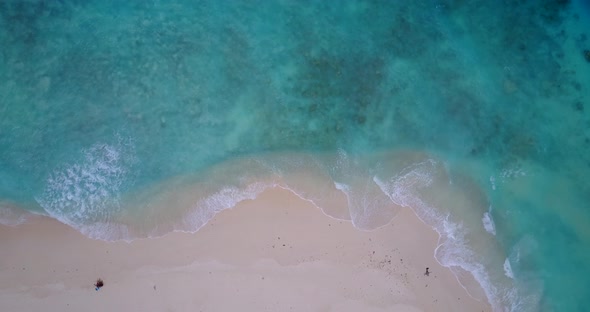 Tropical overhead travel shot of a white paradise beach and blue water background in best quality 4K