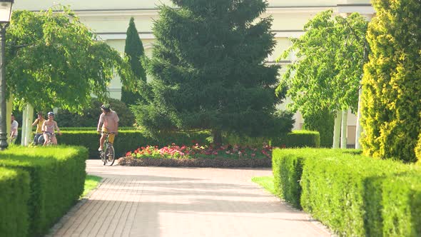 Four Smiling Cyclist Riding in Park