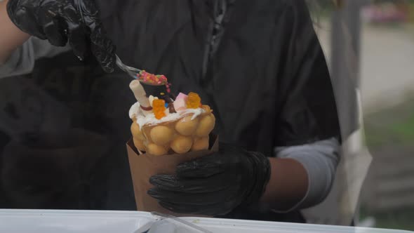 Woman Pours Colorful Sprinkles Onto Dessert in Korean Wafer