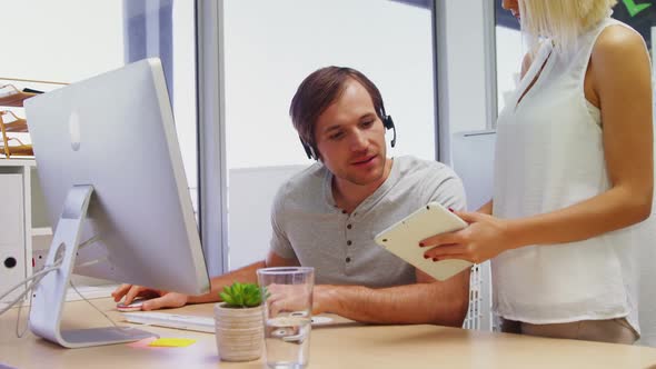 Executives interacting while working on computer and digital tablet 4k