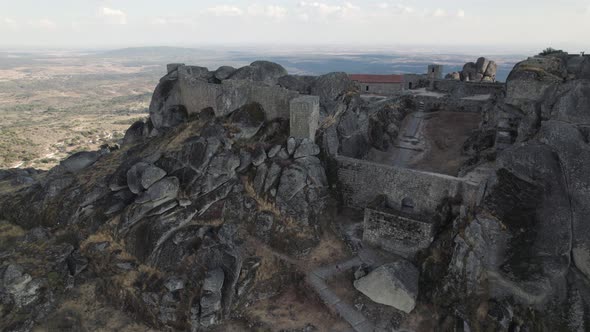 Cinematic shot of amazing Portuguese castle on top of Monsanto mountain, Portugal