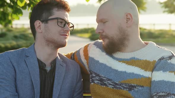 Portrait of Two Affectionate Gay Men Look To Each Other in Eyes. Homosexual Couple Dating in Summer