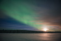 Northern Lights (aurora borealis) and moon, seen over a snow covered lake in winter in Finnish Lapla - PhotoDune Item for Sale