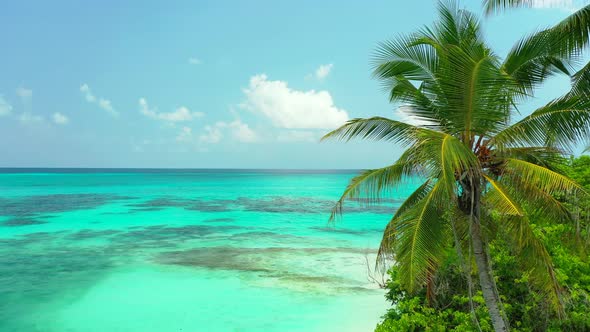 Tropical aerial travel shot of a white paradise beach and blue ocean background in hi res 