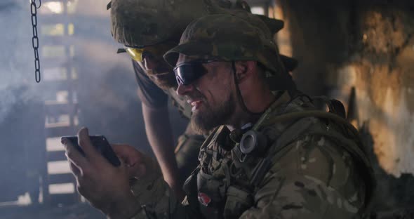 Male Soldiers Using Smartphone Together