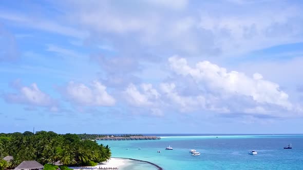 Drone aerial panorama of shore beach trip by blue sea with sand background