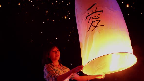 Asian Woman Releases A Sky Lantern