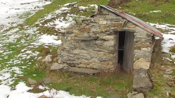 Aerial view of a stone hut in the mountain