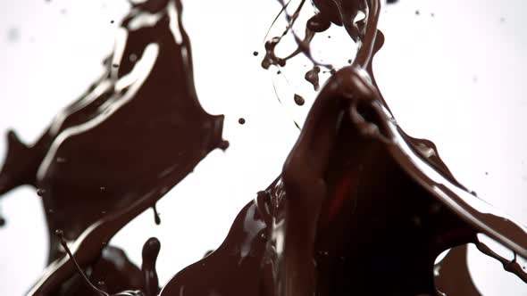 Super Slow Motion Shot of Splashing Melted Chocolate Isolated on White Background at 1000 Fps