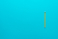 Photo of Yellow Pencil Over Turquoise Blue Background with Copy Space - PhotoDune Item for Sale