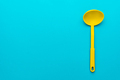 Top View of Yellow Plastic Ladle Over Turquoise Blue Background with Copy Space - PhotoDune Item for Sale