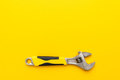 Adjustable Wrench with Yellow Handle on The Yellow Background with Copy Space - PhotoDune Item for Sale